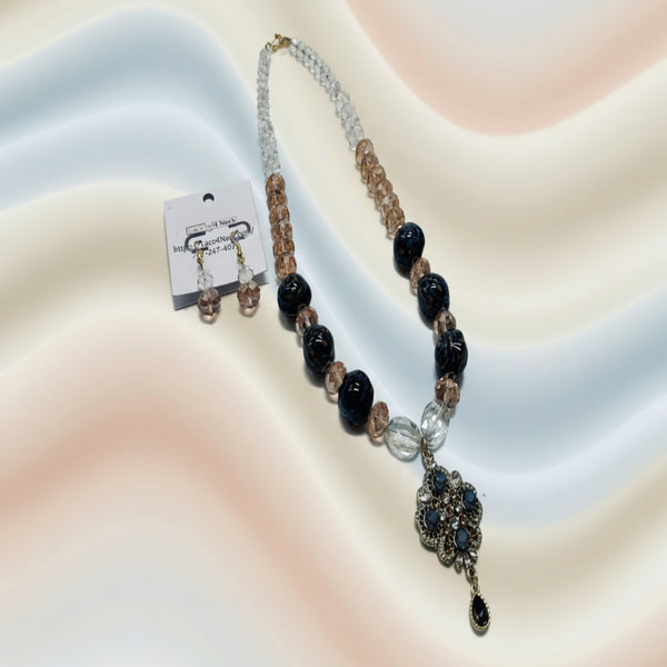 Beaded necklace with black and clear beads on a white background