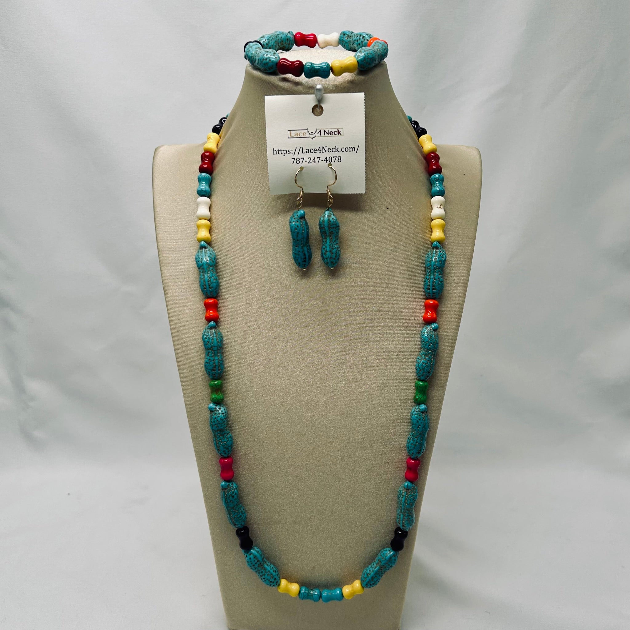 Jewelry set including necklace, earrings, and bracelet on a mannequin bust with a visible brand tag.