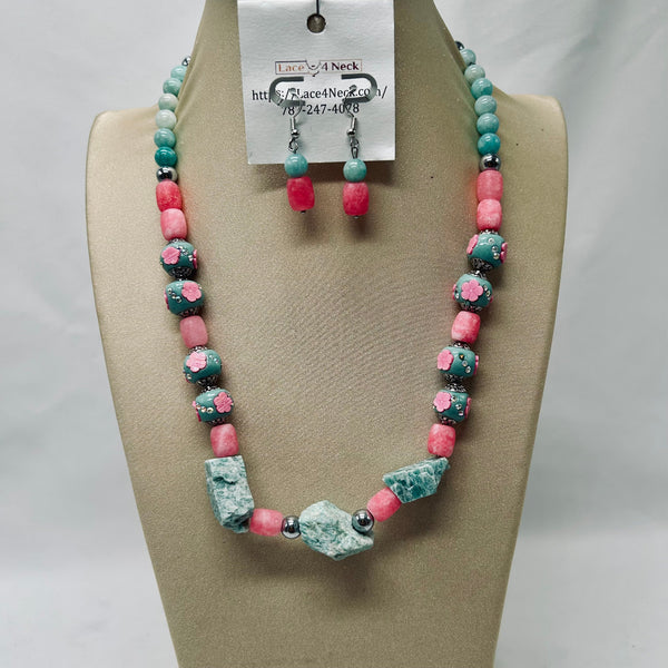 Necklace and earrings set on a mannequin bust with a visible brand tag.