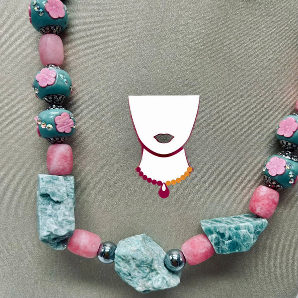 Necklace with colorful beads on a gray background