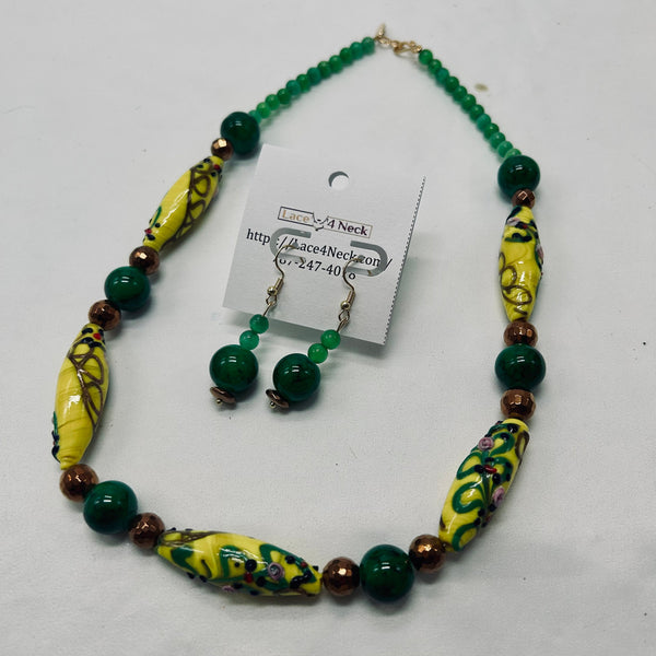 Necklace with yellow and green beads on a white background