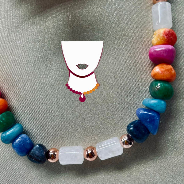 Colorful beaded necklace on a gray fabric background with a small white mask illustration.