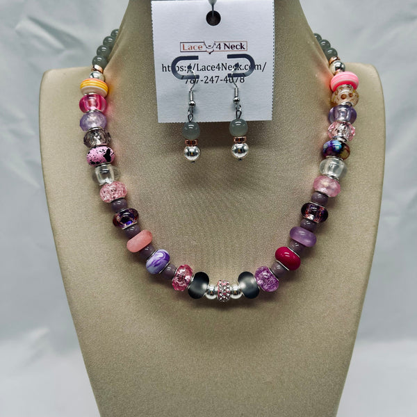 Beaded necklace and earrings set on a mannequin bust with a visible brand label.