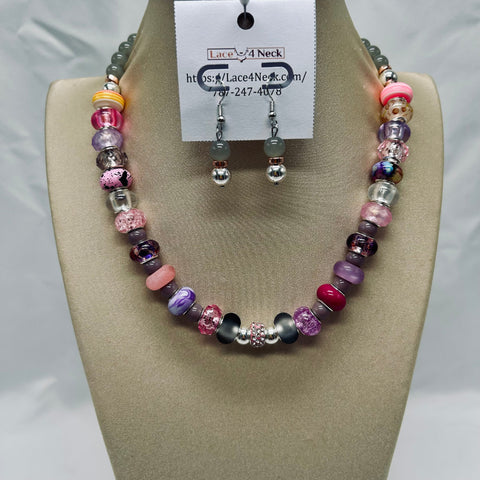 Beaded necklace and earrings set on a mannequin bust with a visible brand label.