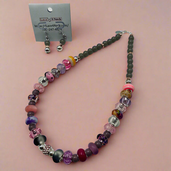 Beaded necklace and earrings on a gray background with a visible brand card.