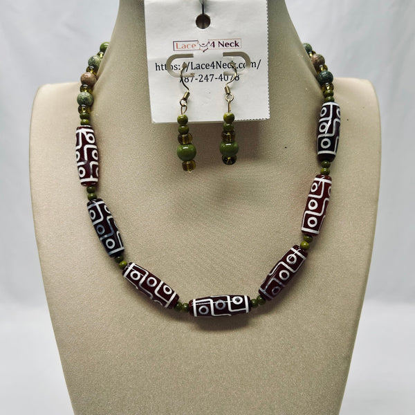 Beaded necklace and earrings set on a mannequin bust with a visible brand tag.