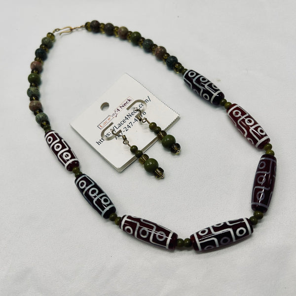 Beaded necklace and earrings set on a white background