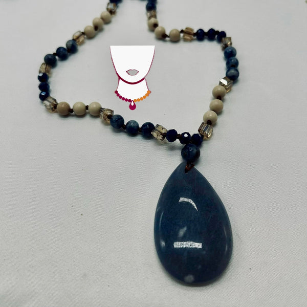 Necklace with a blue teardrop pendant on a light gray background