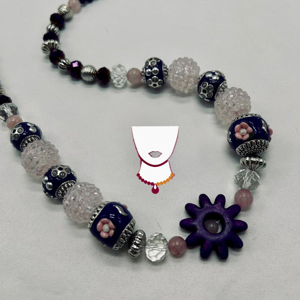 Necklace with various beads on a white background