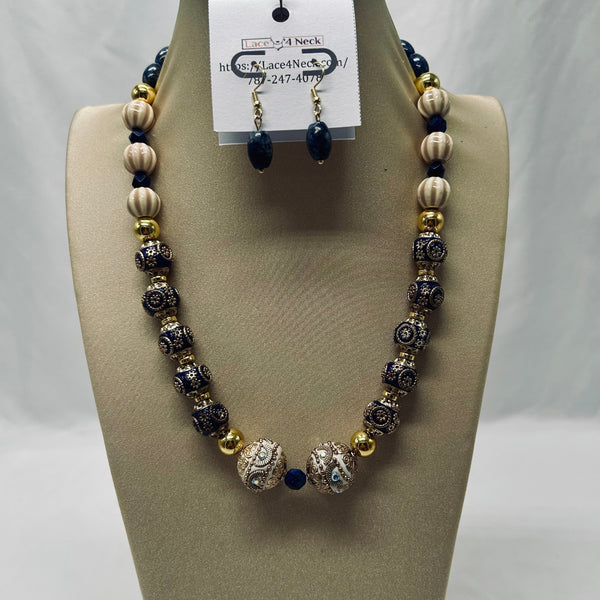 Necklace and earrings set on a mannequin bust with a visible brand tag.