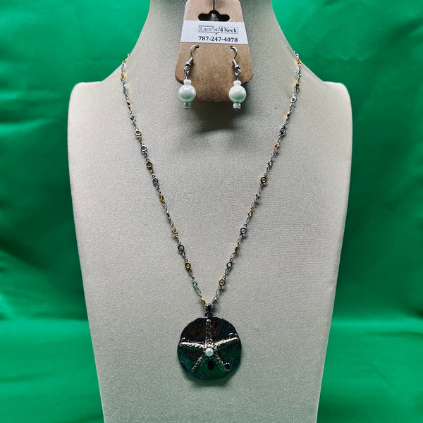 Necklace and earrings on a mannequin bust with a green background