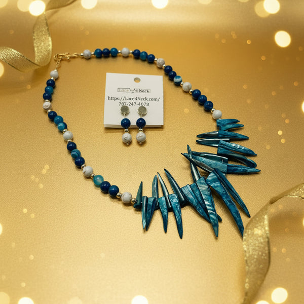Jewelry set with blue and white beaded necklace and spike-like pendant on a white background.