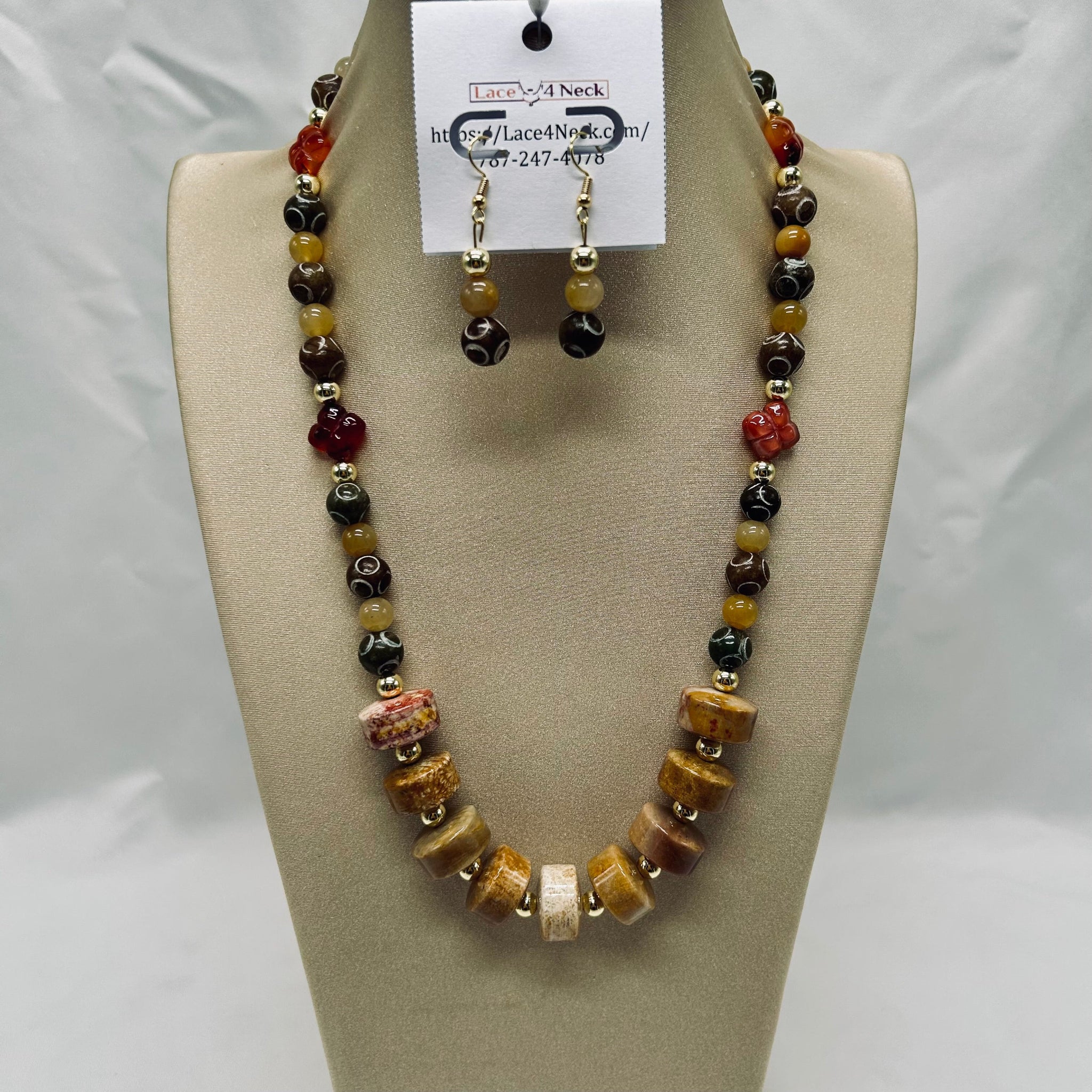 Beaded necklace and earrings set on a mannequin bust with a visible brand tag.