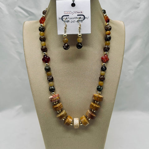 Beaded necklace and earrings set on a mannequin bust with a visible brand tag.