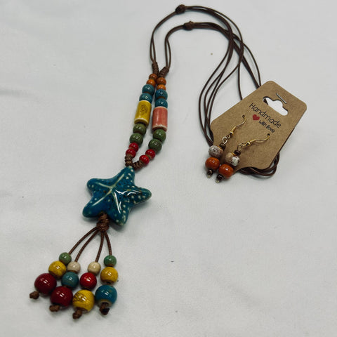 Beaded necklace with star-shaped pendant and matching earrings on a white background