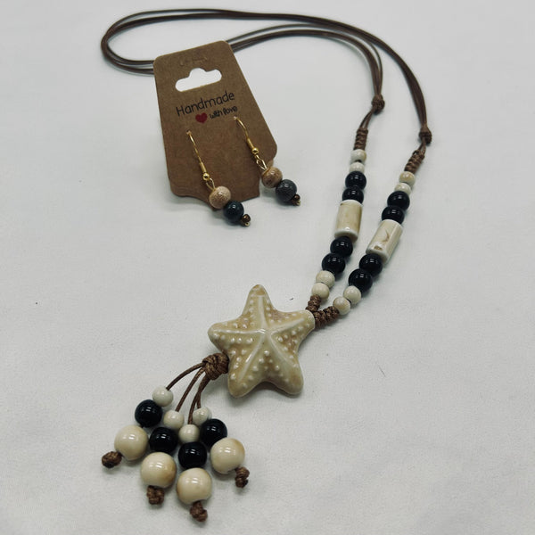 Necklace with star-shaped pendant and beaded chain on a white background