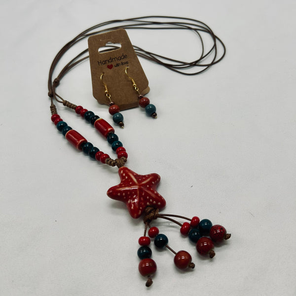 Star-shaped pendant necklace with red and blue beads on a white background