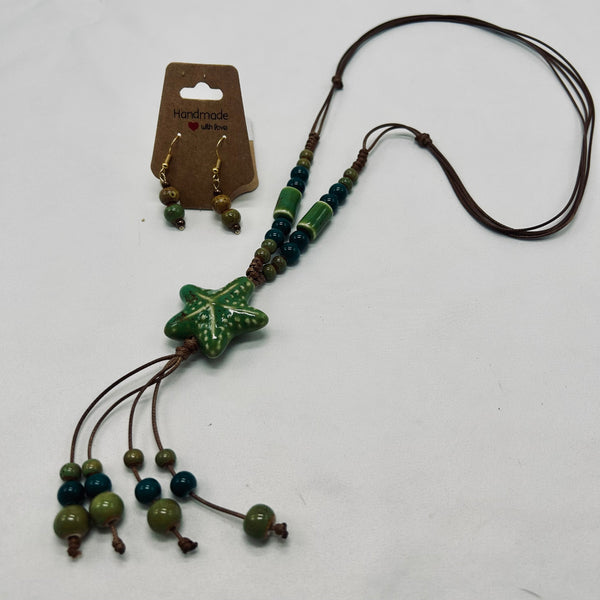 Jewelry set with star-shaped pendant and beaded necklace on a white background