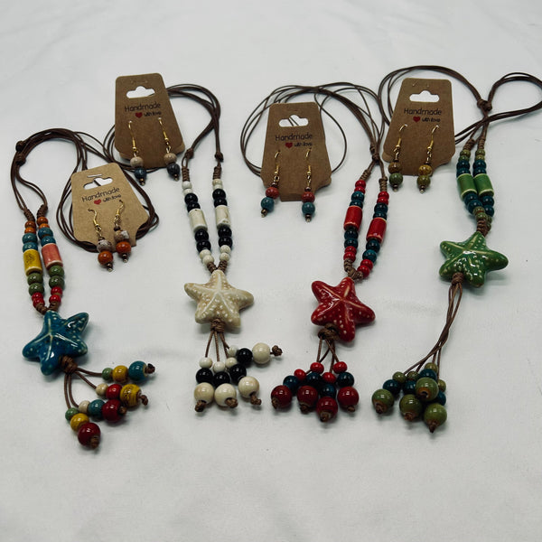Set of colorful beaded necklaces with starfish pendants on a white background