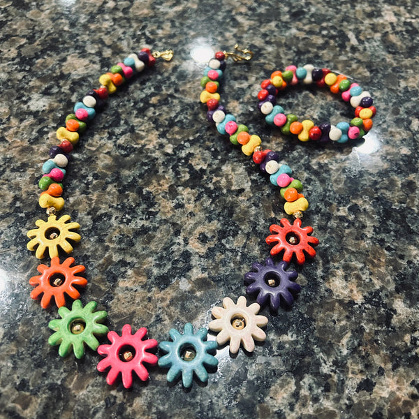 Colorful necklace with flower-shaped beads on a granite surface