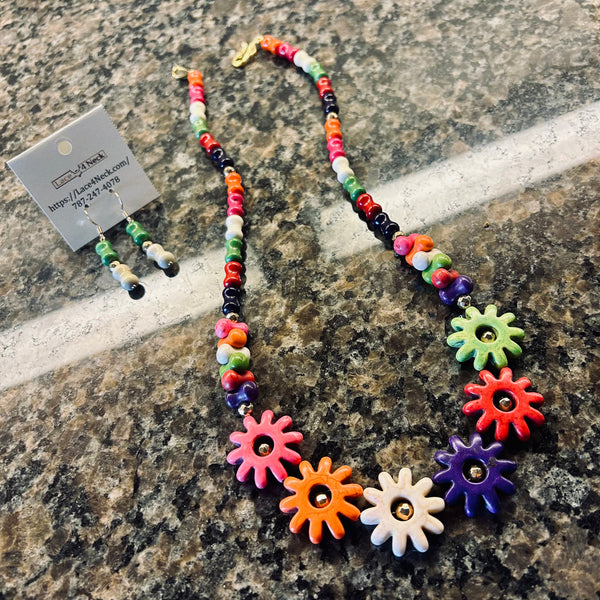 Colorful beaded necklace with flower-shaped beads on a stone surface