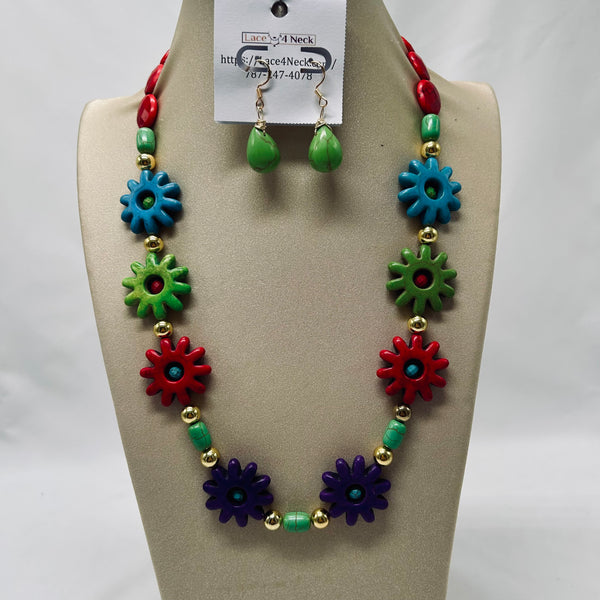 Colorful necklace and earrings set on a mannequin bust with a visible brand tag.