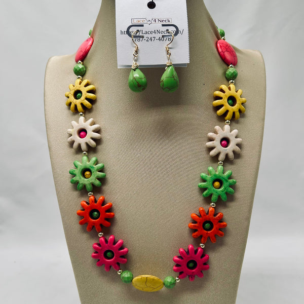 Colorful necklace and earrings set on a mannequin bust with a visible brand tag.