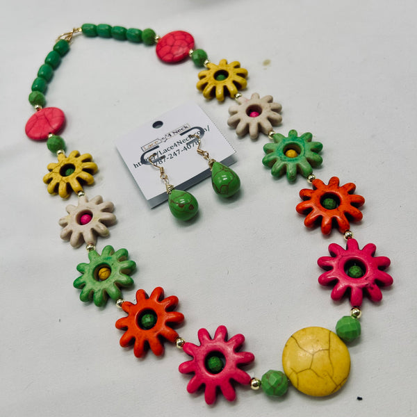 Colorful necklace with floral and round beads on a white background