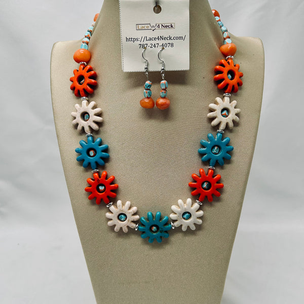 Necklace and earrings set with colorful flower-shaped beads on a display stand.