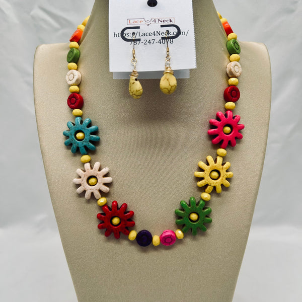 Colorful necklace and earrings set on a mannequin bust with a visible brand tag.