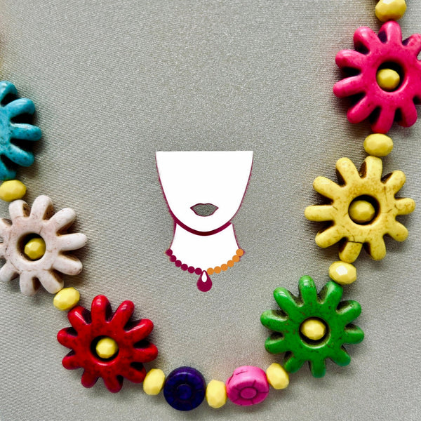 Colorful ceramic flower-shaped beads on a gray background