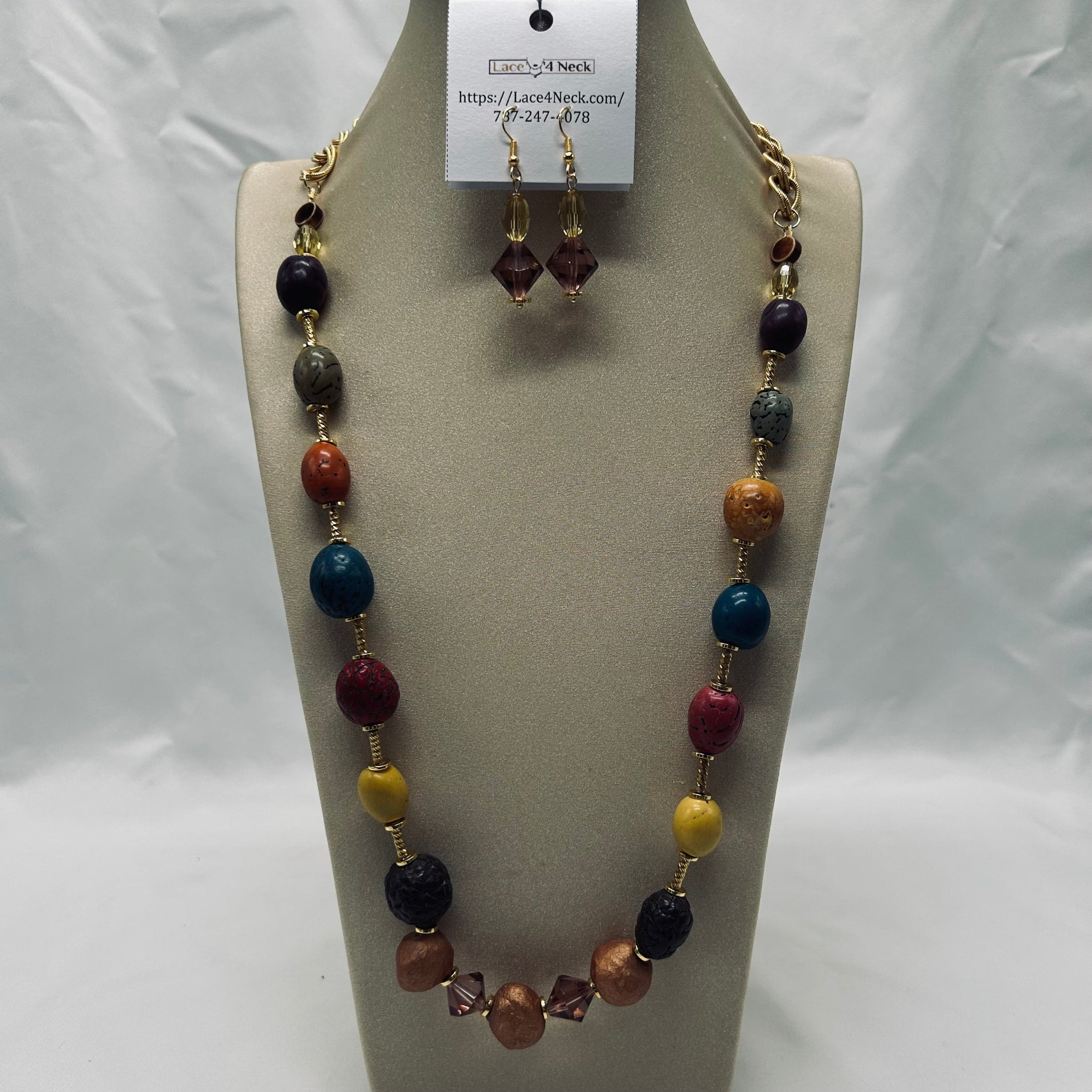 Necklace and earrings set on a mannequin with a white background