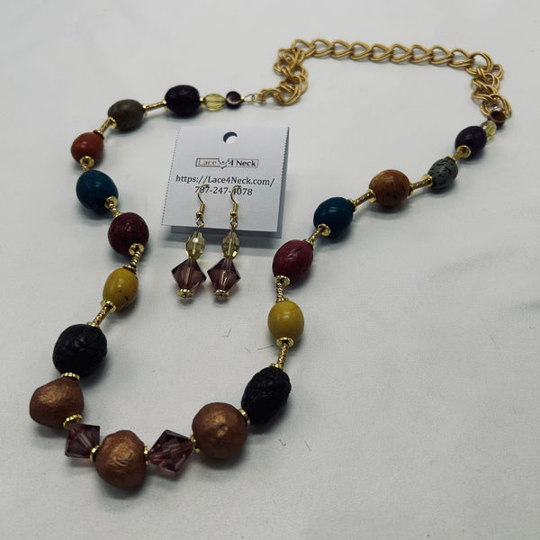 Beaded necklace and earrings set with a gold chain on a white background
