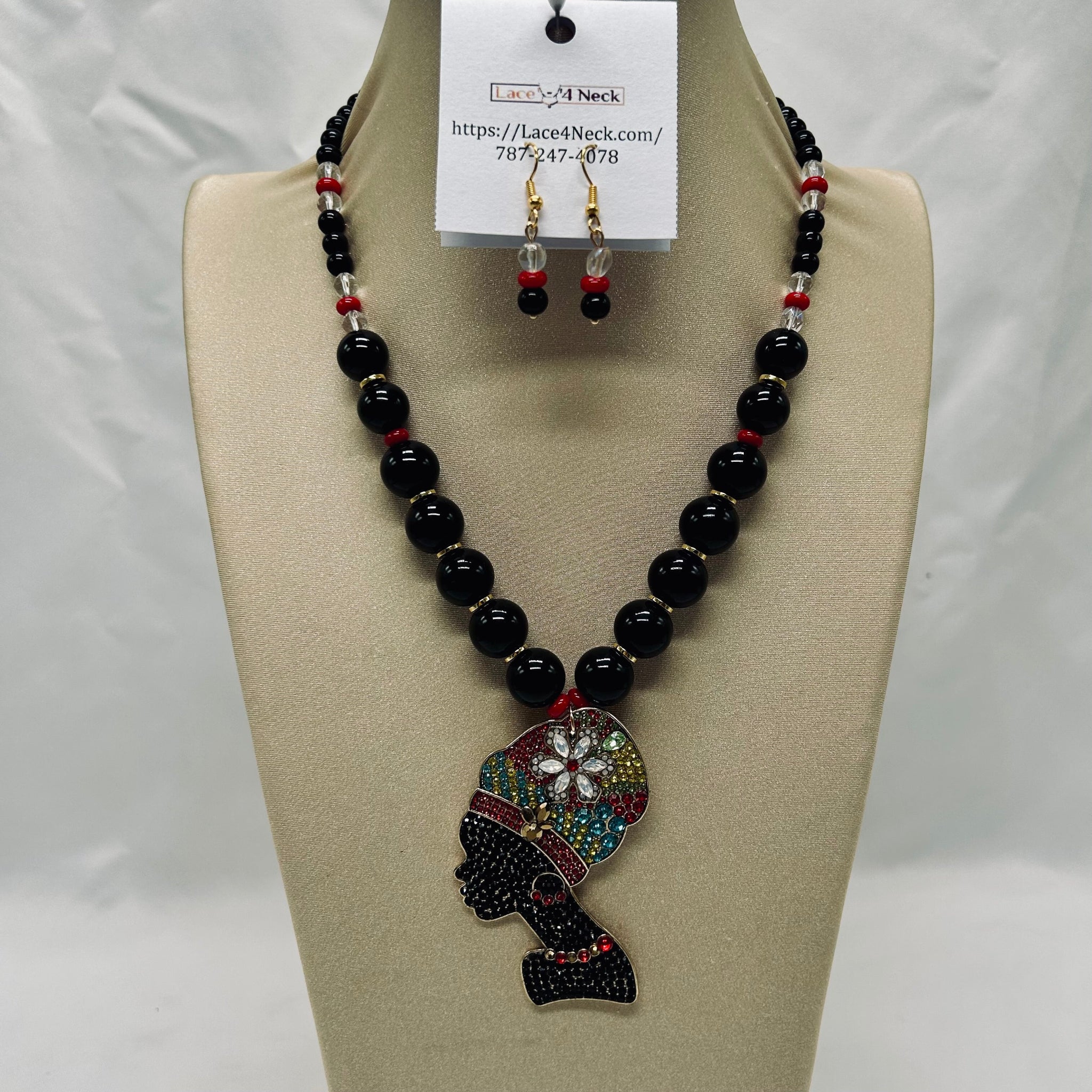 Black beaded necklace with colorful pendant on a mannequin bust, accompanied by matching earrings.