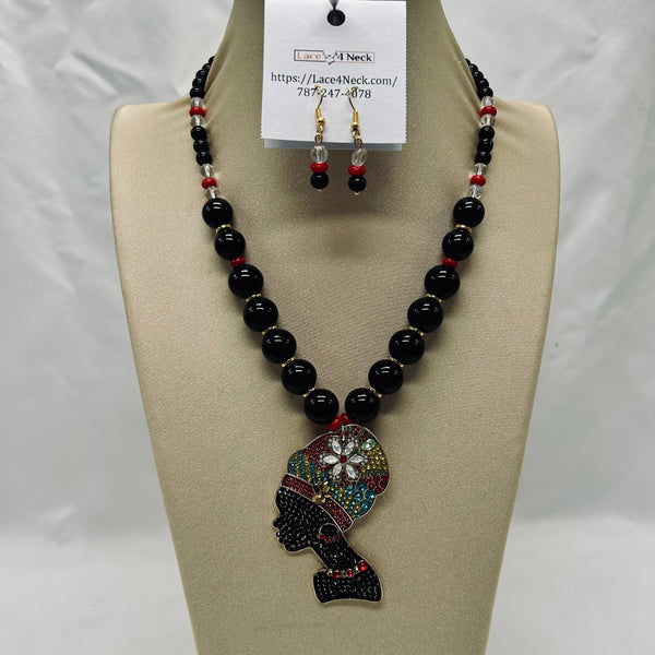 Black beaded necklace with colorful pendant on a mannequin bust, accompanied by matching earrings.