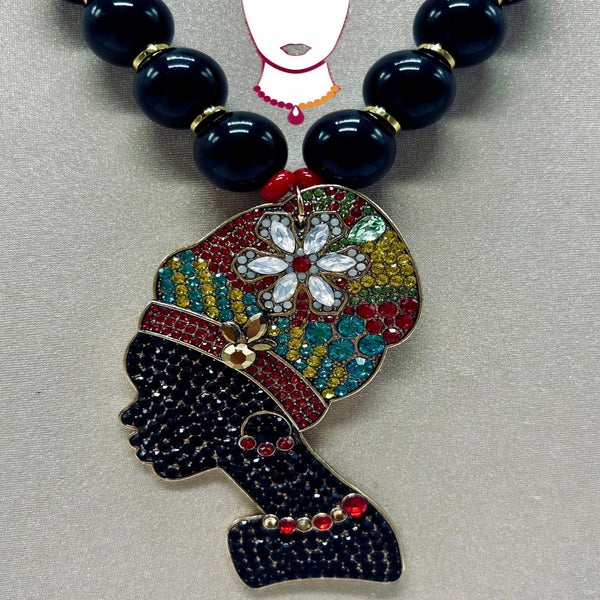 Necklace with a colorful pendant of a woman's head wearing a headscarf on a gray background.