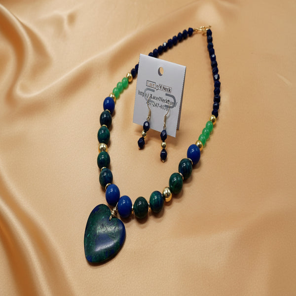 Beaded necklace with a heart pendant and matching earrings on a white background.