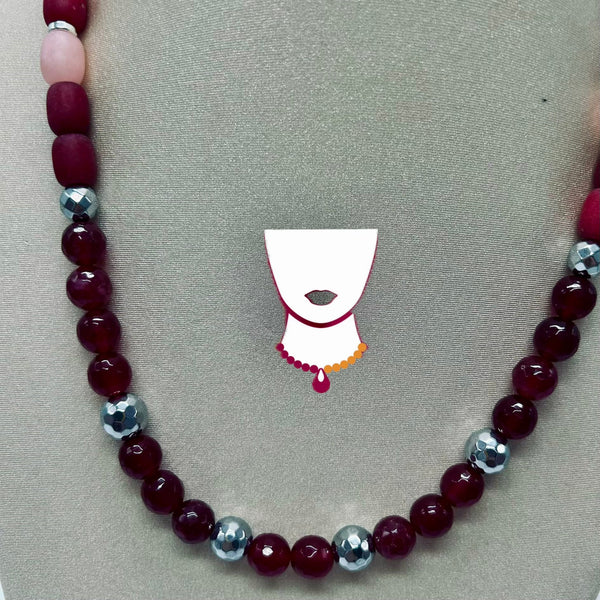 Beaded necklace with red and silver beads on a gray background
