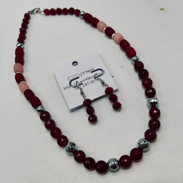 Beaded necklace and earrings set with a card on a white background