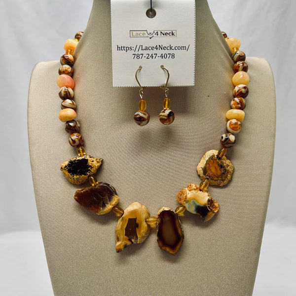 Necklace and earrings set on a mannequin bust with a visible brand tag.