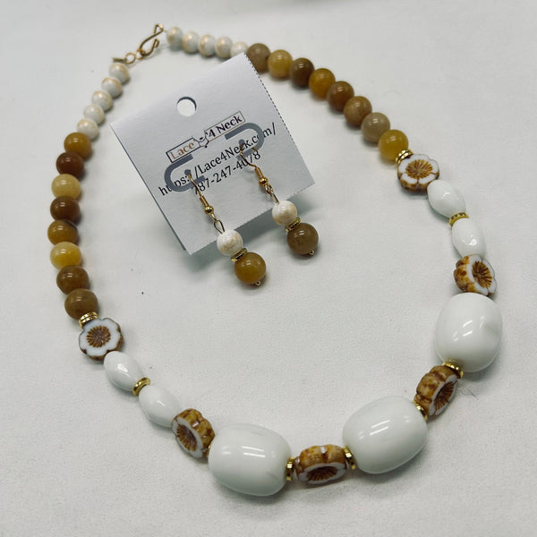 Beaded necklace and earrings set with a card on a white background