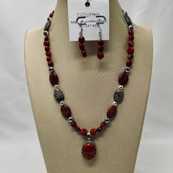 Necklace and earrings set on a mannequin bust with a visible brand tag.