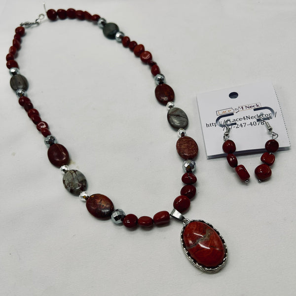 Necklace with red and silver beads on a white background