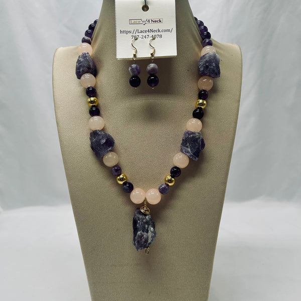 Necklace and earrings set on a mannequin bust with a visible brand label.