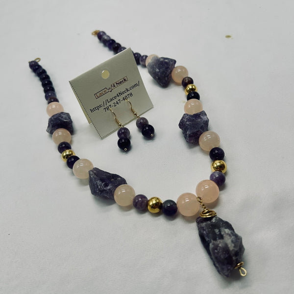 Necklace and earrings set with purple and pink beads on a white background