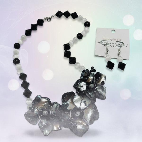 Black and white floral necklace and earrings on a white background