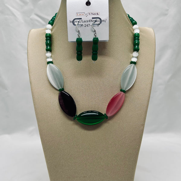 Jewelry set with necklace and earrings on a beige display stand.