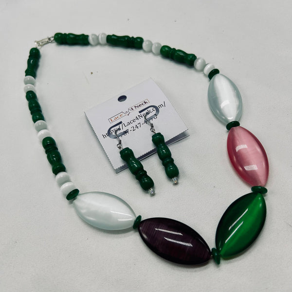 Necklace and earrings set with green, white, and purple beads on a white background