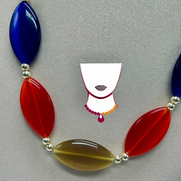 Necklace with blue, red, and brown beads on a gray background