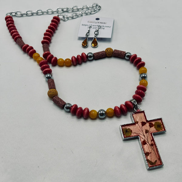 Necklace with red beads and a cross pendant on a white background